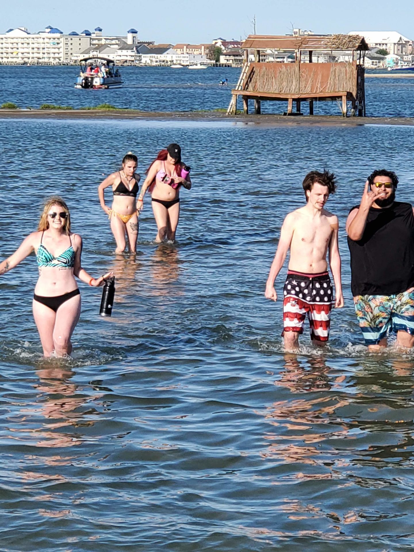 a group of people standing next to a body of water
