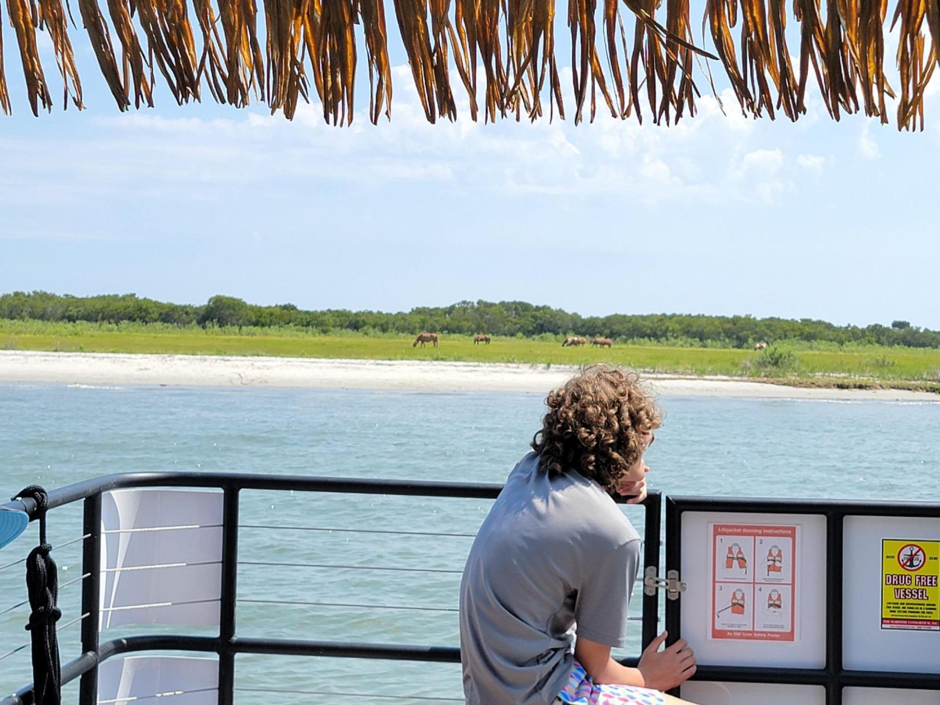 a man and a woman standing in front of a body of water
