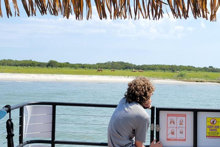 a man and a woman standing in front of a body of water
