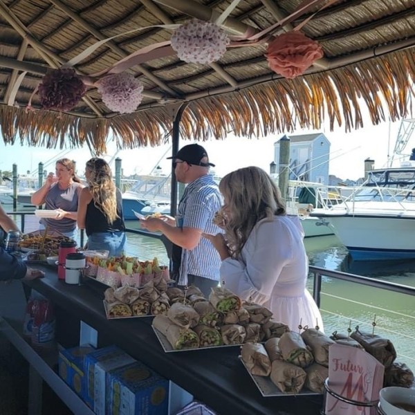 a group of people preparing food on a table