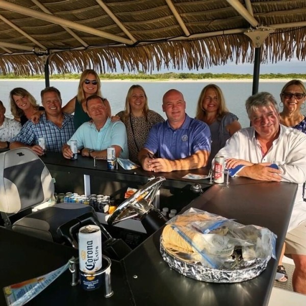a group of people sitting at a table posing for the camera